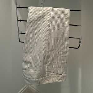 The limited slacks, ankle length with white piping detail.